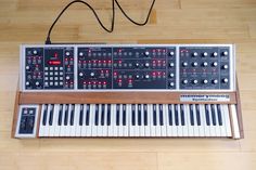 an electronic keyboard sitting on top of a wooden floor