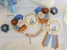 a bunch of flowers that are on top of a table with some ribbon around it