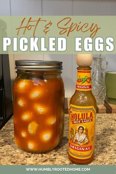 hot and spicy pickled eggs in a jar next to a bottle of hot sauce