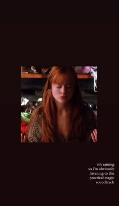 a woman with long red hair standing in front of a shelf