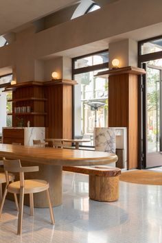 a large kitchen with wooden cabinets and marble counter tops