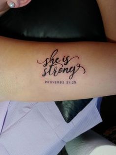 a woman with a tattoo on her arm that says she is strong and proves prove