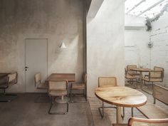 an empty room with wooden tables and chairs