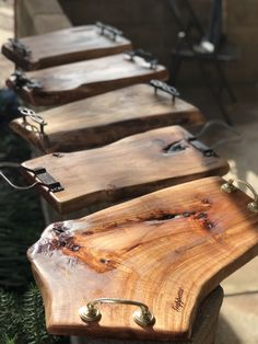 several wooden benches lined up next to each other in a row on the ground outside