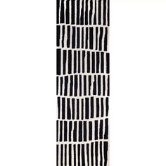 a black and white striped rug with vertical lines on the bottom, diagonally drawn across it