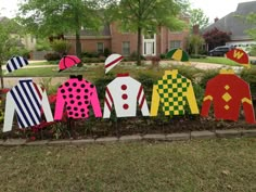 a group of paper cut out jockeys in front of a house