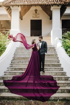 a man and woman standing on some steps