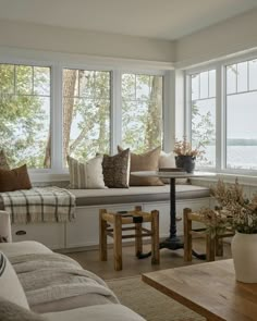 a living room filled with furniture and lots of windows