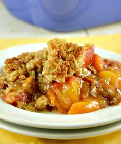 a close up of a plate of food with fruit and crumbs on it