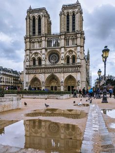 the reflection of two large cathedrals in a puddle