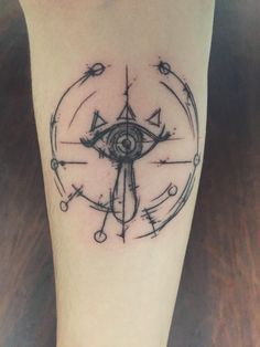 a compass tattoo on the leg of a person