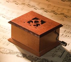 a wooden music box with an animal on it