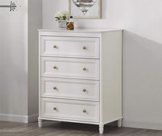 a white chest of drawers in a room