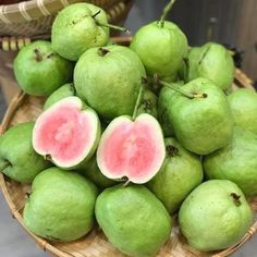 a basket filled with lots of green fruit