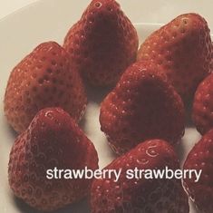 strawberries are arranged on a white plate with the words strawberry strawberry written below them