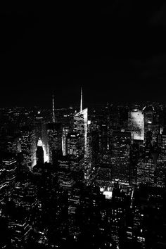 black and white photograph of new york city at night from the top of the empire building