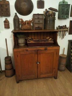 an old wooden cabinet with many items on it