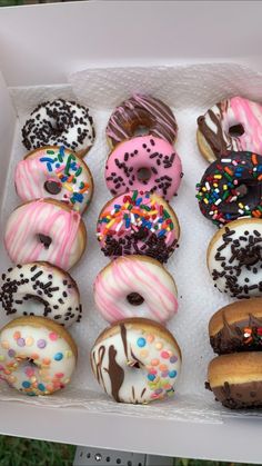 a box filled with lots of different flavored donuts