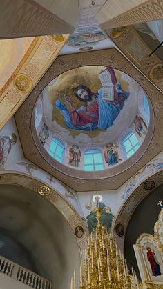 an ornate ceiling with paintings and chandeliers