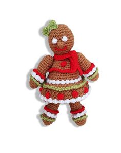 a small crocheted teddy bear dressed in red and green dress with white trim