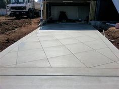 an unfinished driveway being built in front of a house