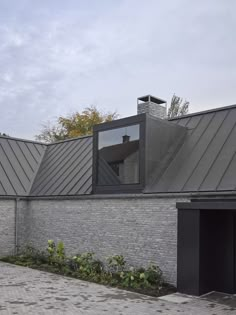 a brick building with a metal roof and windows