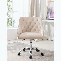 an office chair with wheels and a beige upholstered fabric seat is in front of a window