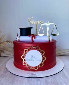 a red cake with gold decorations and a judge's gavel on top that says france