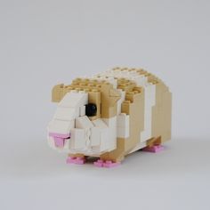 a toy sheep made out of legos on a white surface