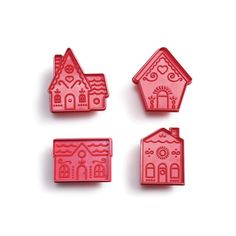 three small houses are shown on a white surface, one is pink and the other is red