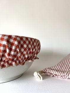 a red and white checkered cloth sitting on top of a bowl