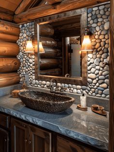 a stone sink in a rustic log cabin bathroom