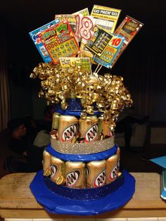 a cake made to look like a stack of soda cans with candy bars on top