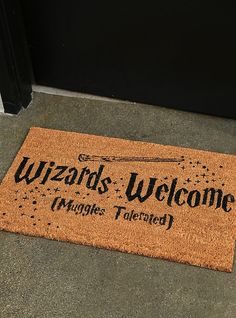 a welcome mat that says wizard's welcome hangs tailored in front of the door