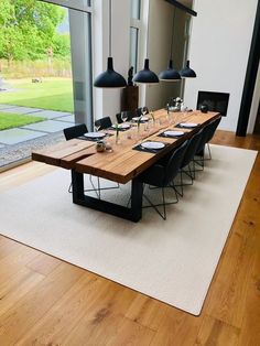 a dining room table is set with black chairs and place settings for six people to eat