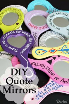 a group of different colored mirror frames with words on the front and sides, all decorated to look like children's mirrors