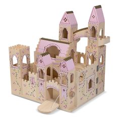 a wooden toy castle with pink walls and turrets on the front, set against a white background