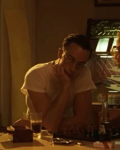 a man sitting at a table playing chess