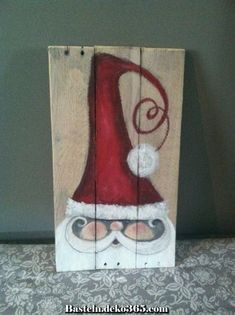 a piece of wood that has been painted with santa's hat and glasses on it