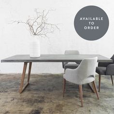 a dining table with two chairs and a vase on the top that says available to order