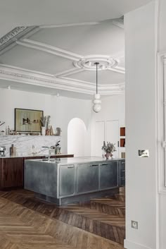 an open kitchen with wooden floors and white walls