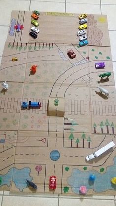 a child's play mat with cars and trucks on it, sitting on the floor