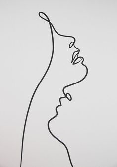 a line drawing of a woman's face on a white wall with black lines