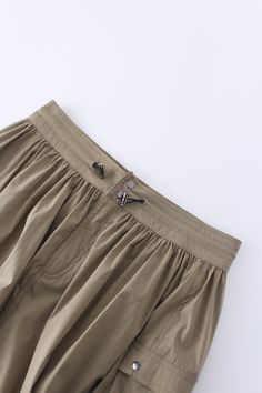 This Waist Pull Skirt-Khaki is a versatile addition to any wardrobe. Featuring a unique waist pull design, this skirt allows for a comfortable and flattering fit for everyone.