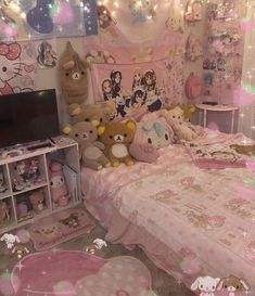 a bedroom decorated in pink and white with hello kitty decorations