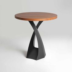 a wooden table with black metal legs and a wood top on a white background in the shape of an x