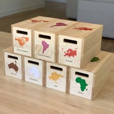 four wooden boxes with different colored maps on them