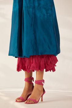 Blue layered dress with thread, sequin, bead embroidered cluster motifs, front pleats and attached pink smocked uneven bottom layer. - Aza Fashions Fitted Dresses With Layered Hem Long Skirt, Elegant Dresses With Layered Hem, Silk Long Skirt Dress With Ruffles, Traditional Blue Dress With Ruffles, Traditional Blue Ruffled Dress, Festive Embellished Tiered Skirt Dresses, Traditional Tiered Skirt Dress For Spring, Traditional Spring Dresses With Tiered Skirt, Elegant Blue Dress With Embroidered Hem