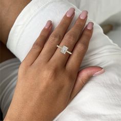 a woman's hand with a diamond ring on it