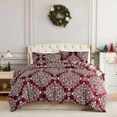 a red and white bed in a room with christmas decorations on the wall behind it